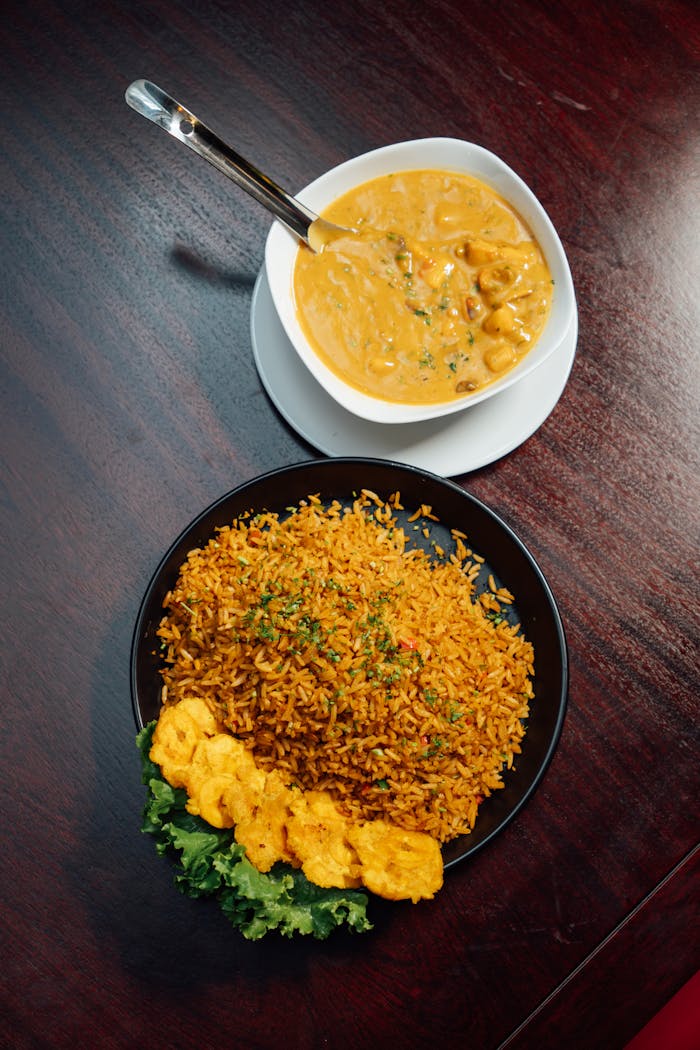 A vibrant plate of jollof rice with bean sauce, highlighting West African cuisine.