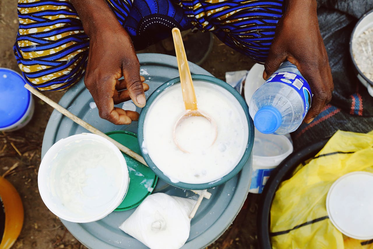 Close-up of traditional Nigerian drink preparation in Abuja, Nigeria showcasing hand-scooped beverage.